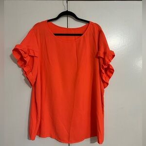 Coral blouse with ruffle detail on sleeves